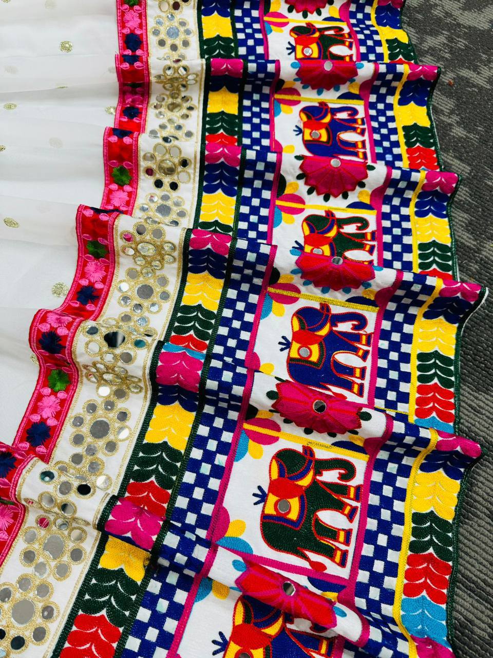 Exquisite Pristine White Designer Lehenga Choli with Vibrant Multicolored Traditional Elephant Embroidery and Mirror Work Detailing